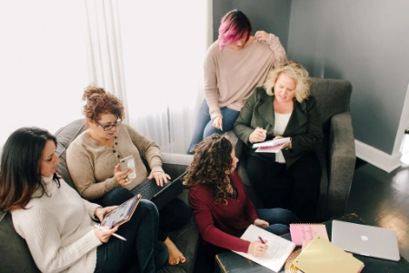 Kim Woods leading a small group session, guiding participants through rhythm calibration to align energy and intention.