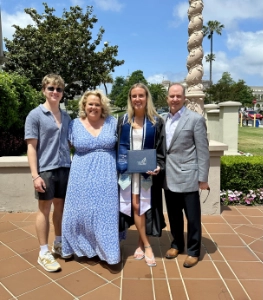 Kim Woods with her family at a graduation ceremony, embodying the strength, pride, and grounding of Sovereignty Anchored.
